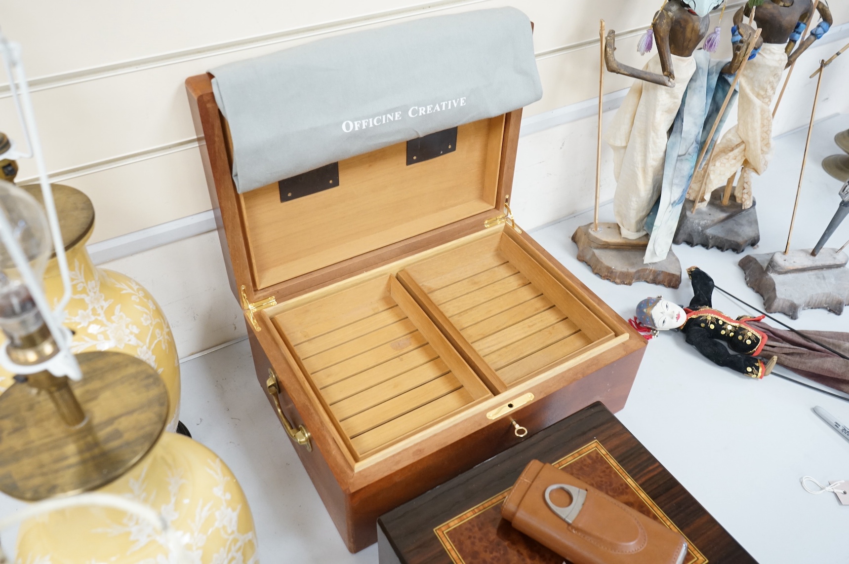 Two wooden humidors, one inlaid, together with a leather cigar case, largest 42cm x 30cm.